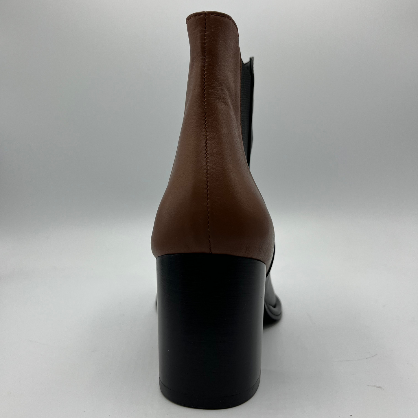 Black and brown ankle boot with black block heel on a white background