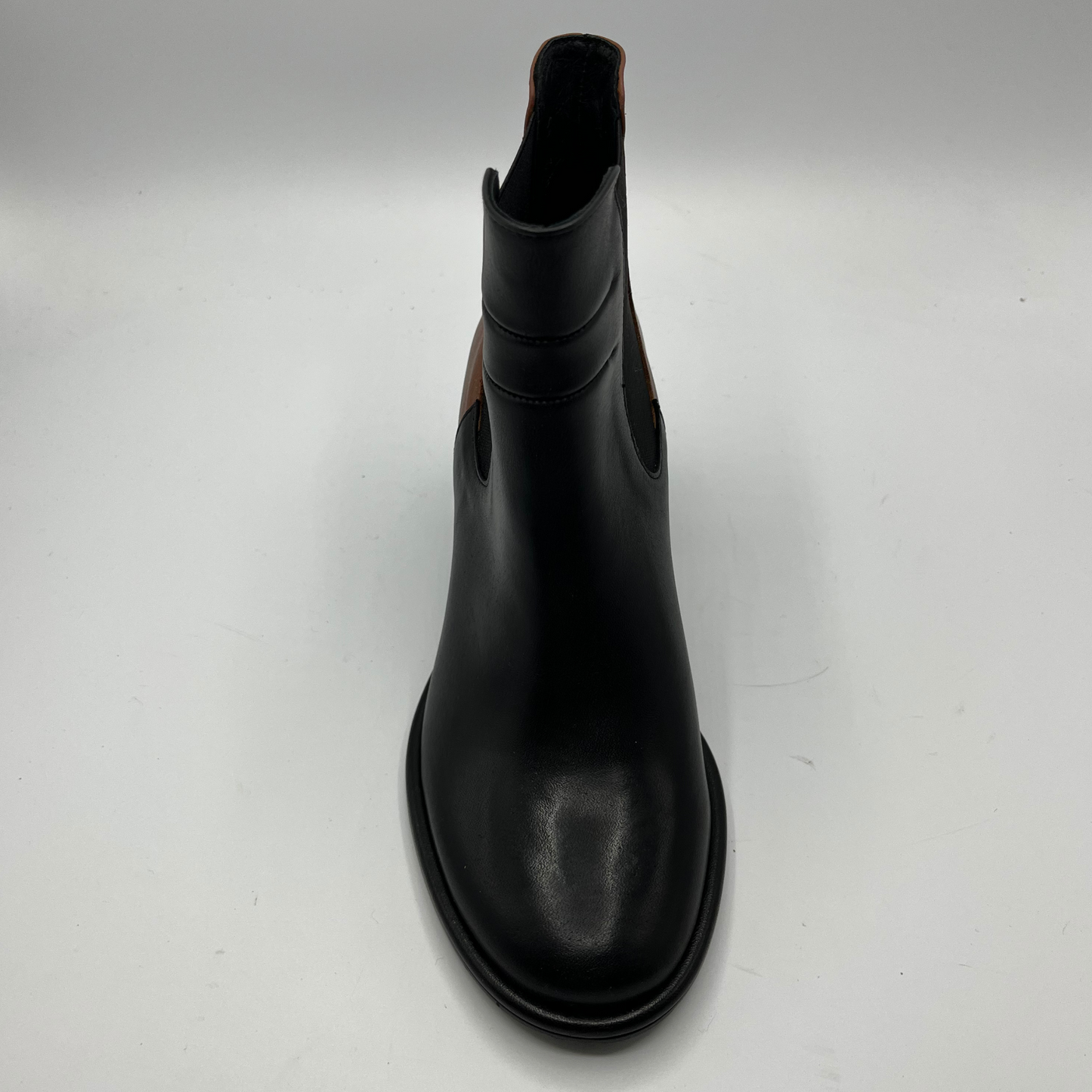 Black leather boot on a white background