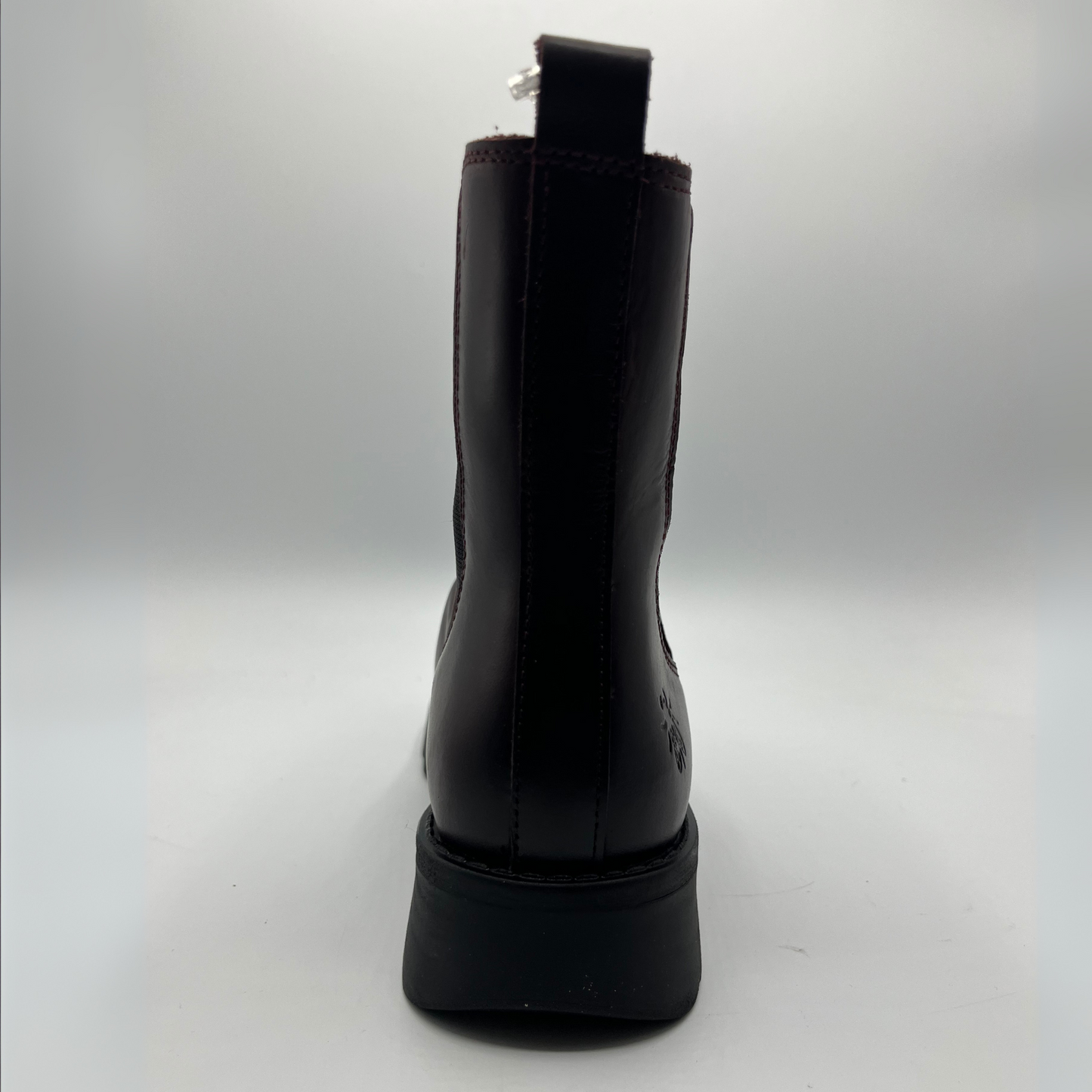 Wine coloured boot on a light gray background