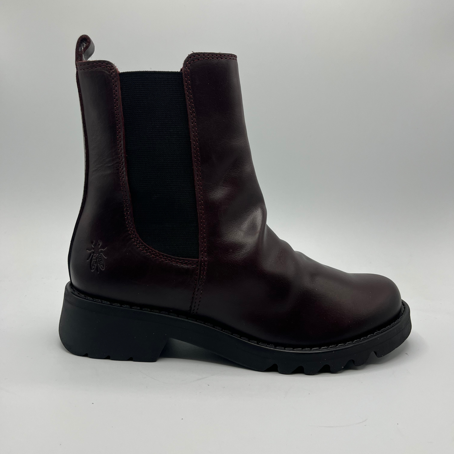 Wine leather boot on a white background