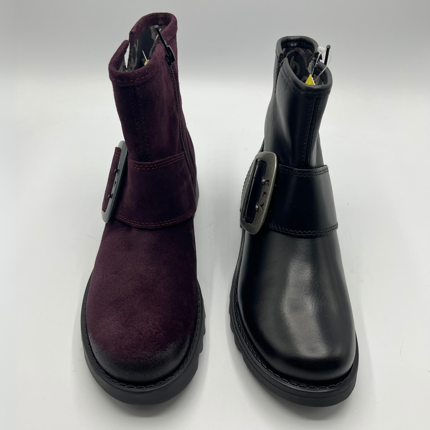 Pair of purple and black boots on a white background