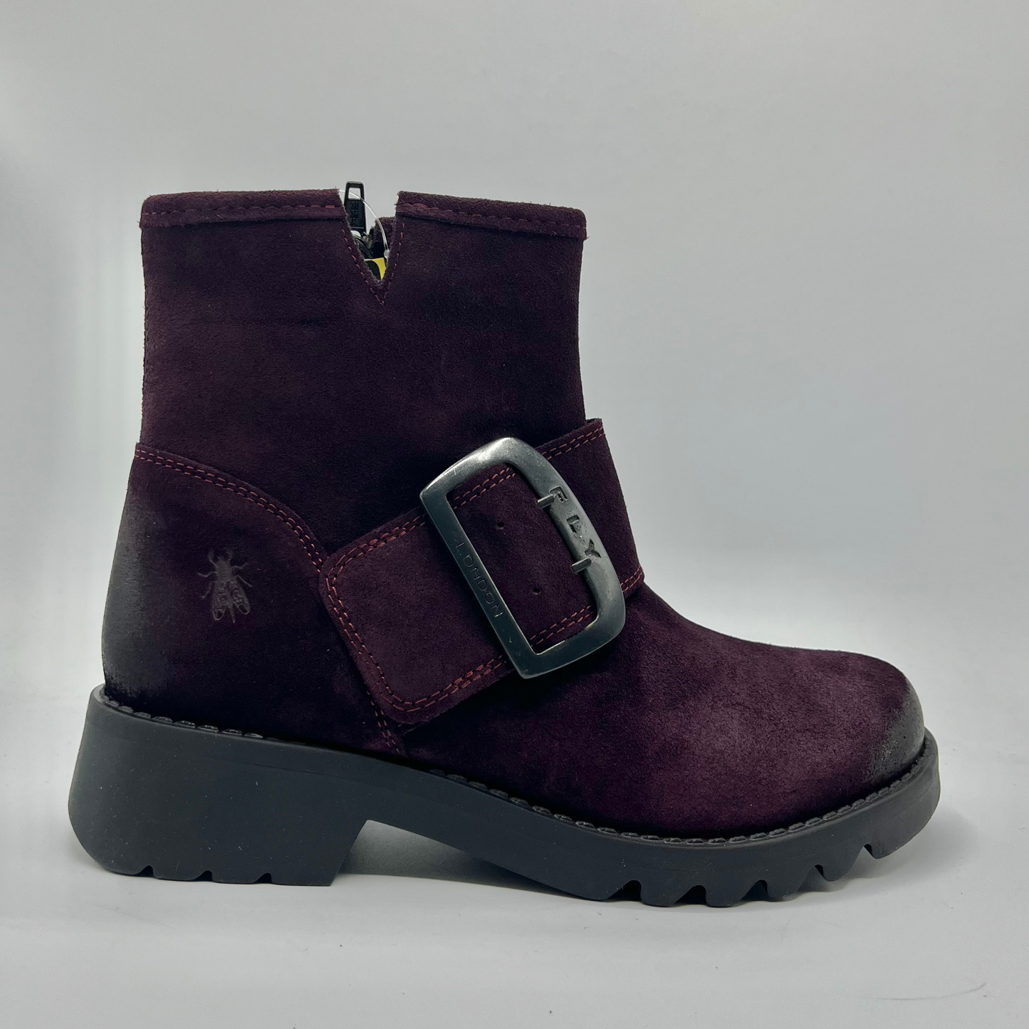 Purple boot with a buckle on a white background