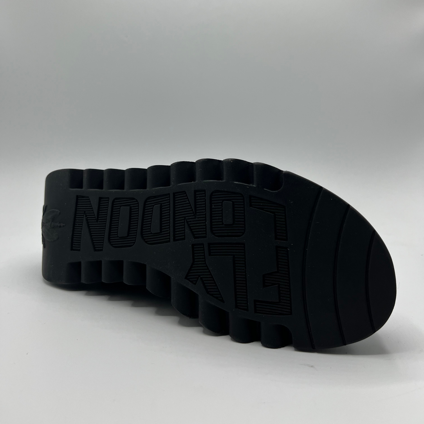 Black sole of a shoe with 'Fly London' branding on a white background