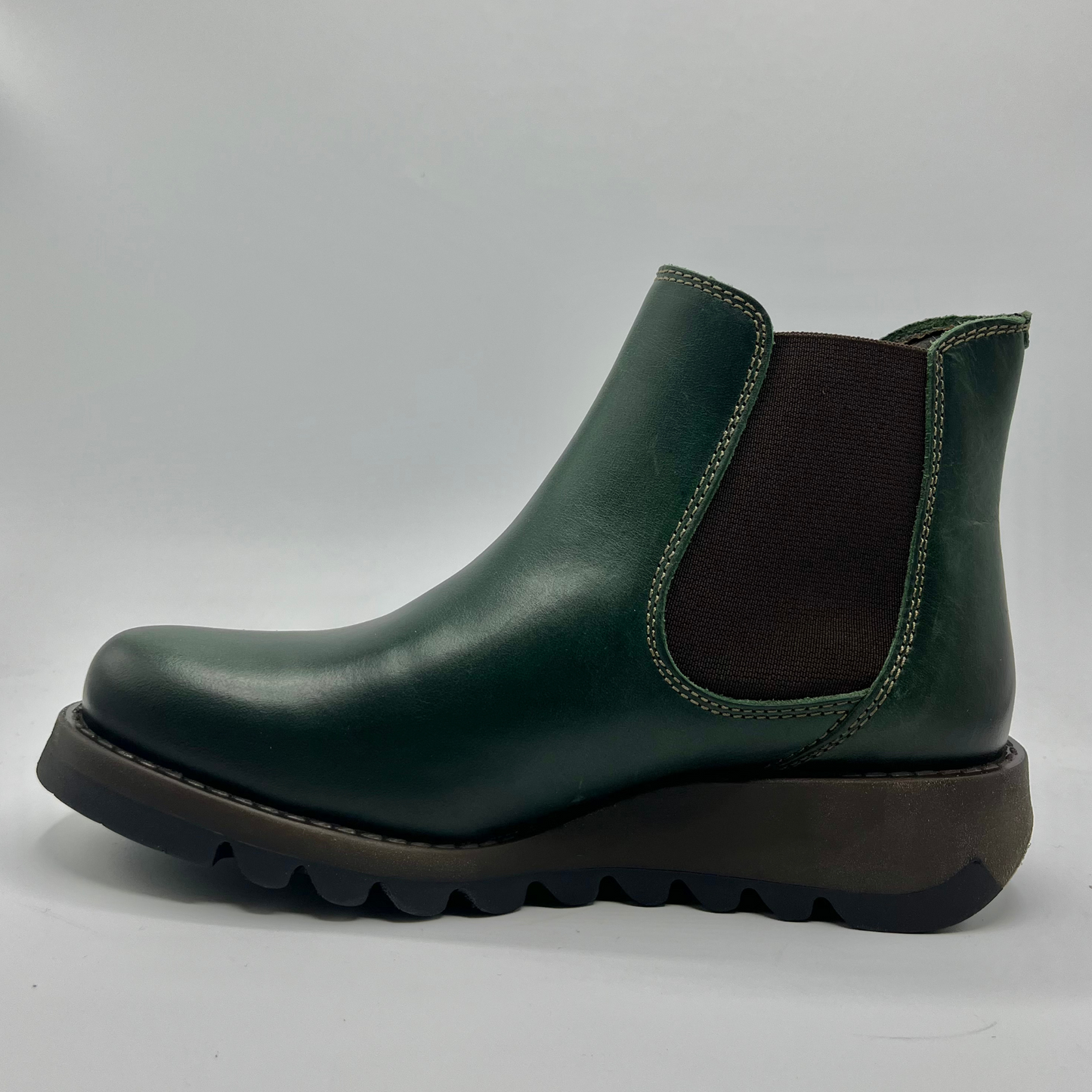 Green Chelsea boot on a white background