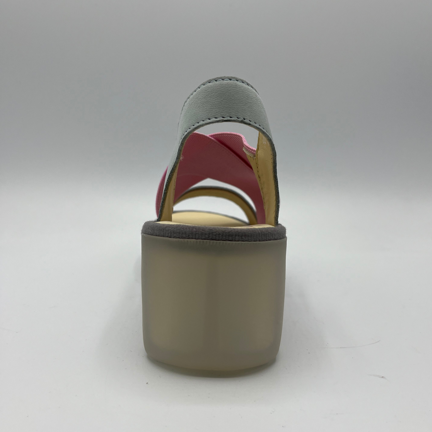 Back view of a stretchy pull on shoe with a leather sling back and toe strap. Featuring thick supportive platform sole