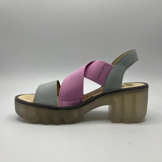 Left facing view of a stretchy pull on shoe with a leather sling back and toe strap. Featuring thick supportive platform sole