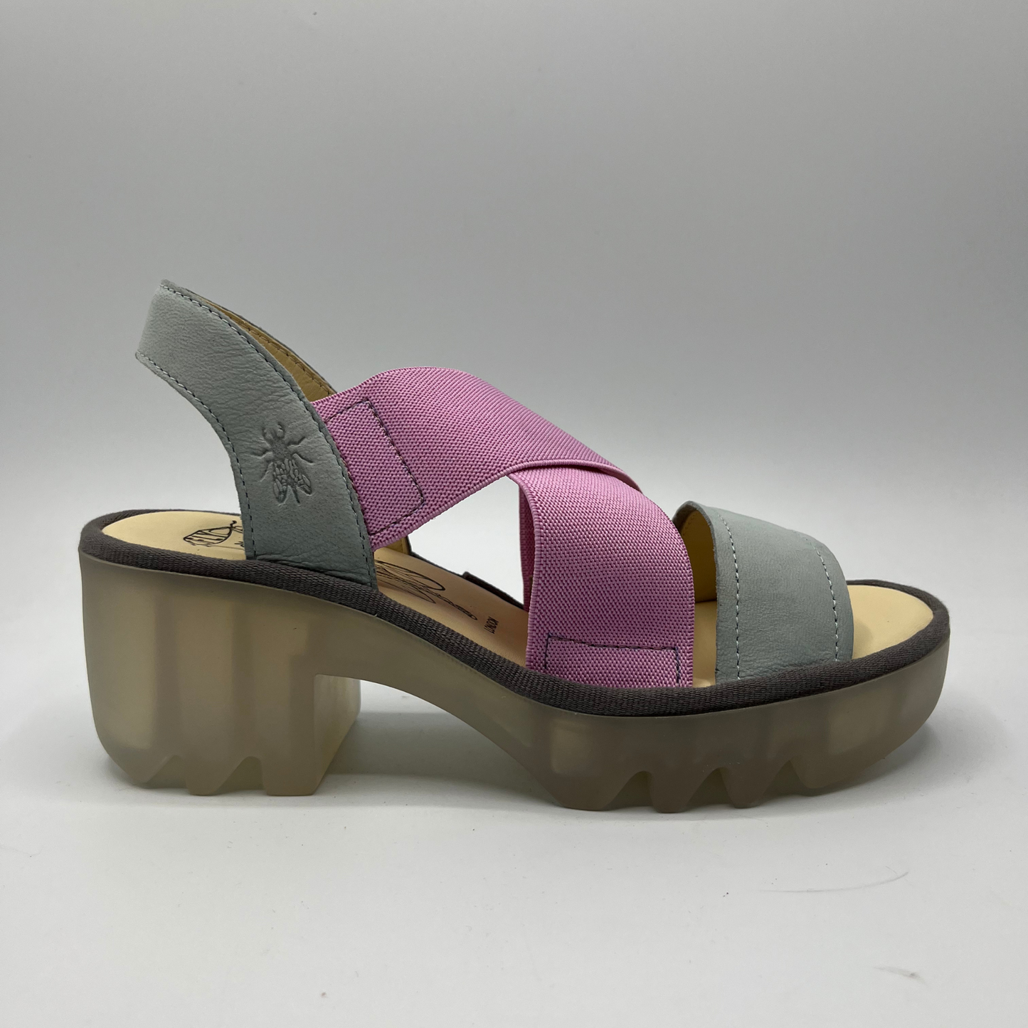 Right facing view of a stretchy pull on shoe with a leather sling back and toe strap. Featuring thick supportive platform sole