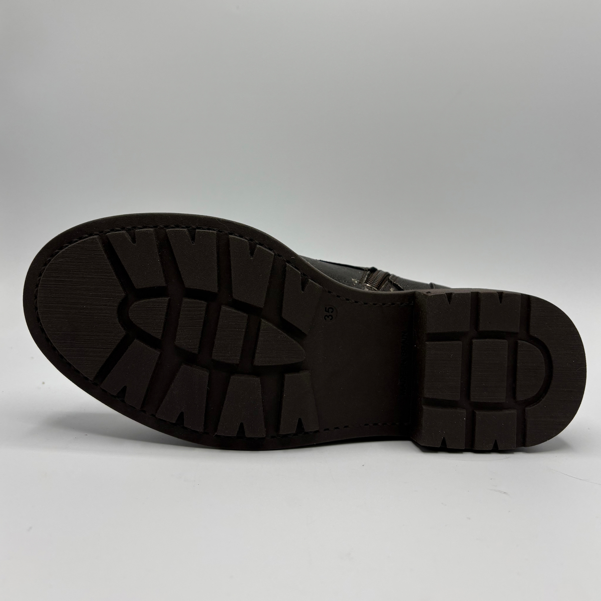 Bottom view of a weather look leather boot with a leopard print tongue
