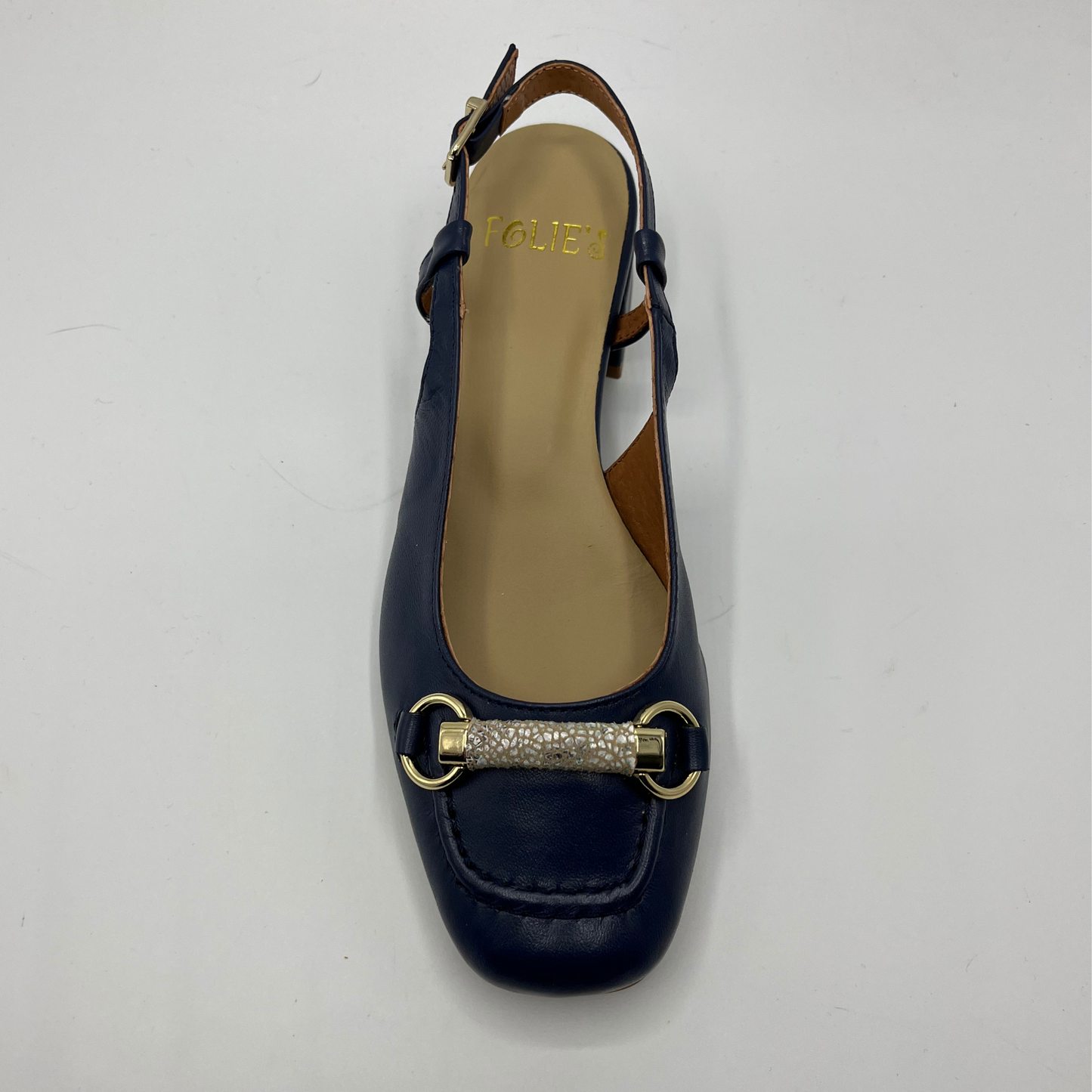 Top view of a navy leather slingback loafer with an adjustable buckle, wrapped heel and a squared toe.