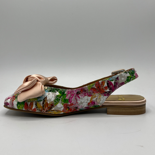 Left facing view of a floral shoe with a short block heel, an adjustable slingback strap and a pink satin bow on the toe.
