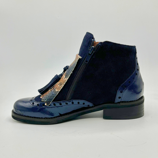 Blue ankle boot with a tassel accent on a white background