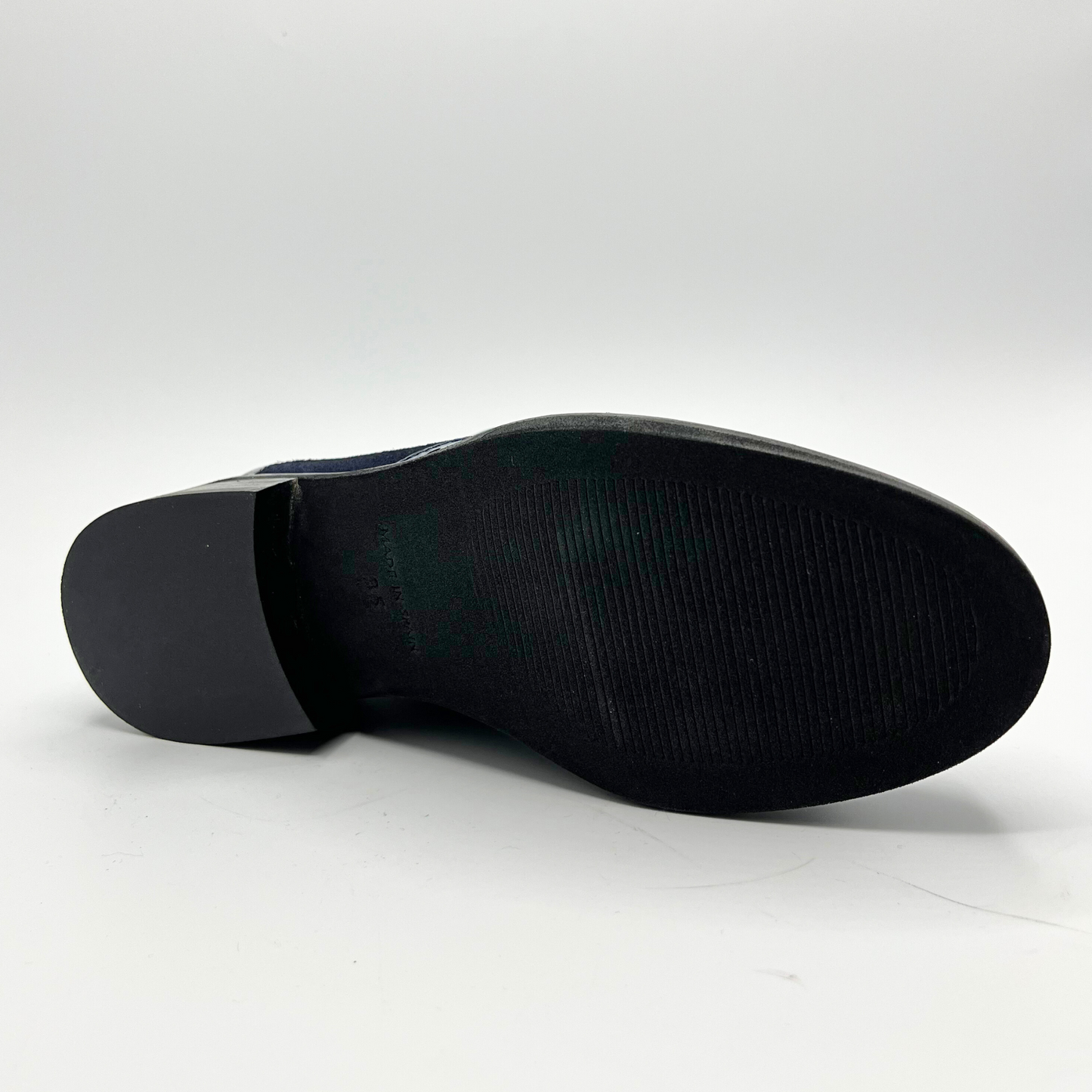 Close-up of a black shoe sole on a white background