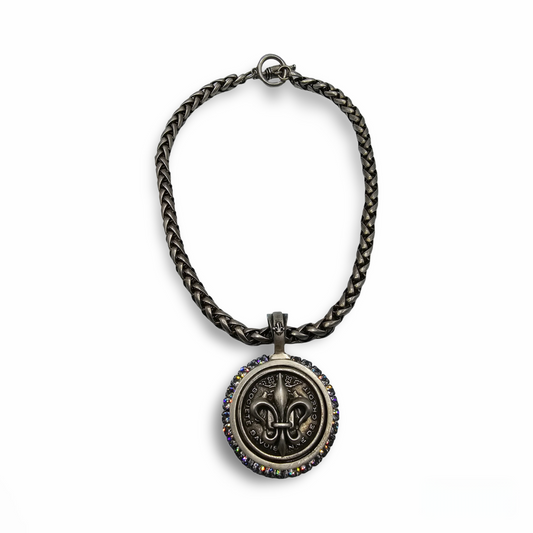 View of a 17" long silver plated necklace with a fleur de lis medallion.