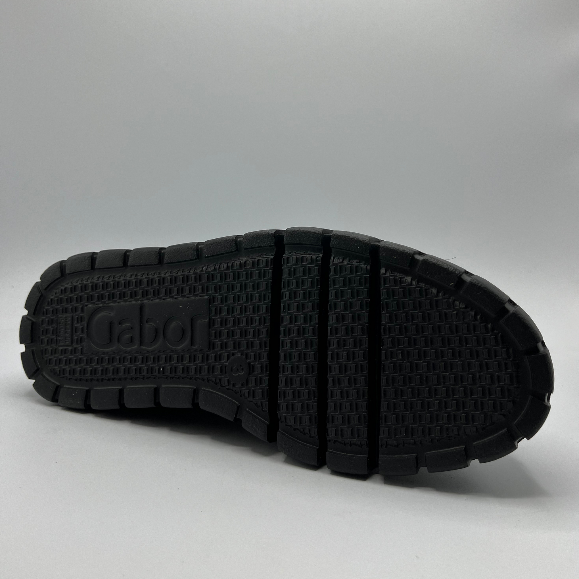 Black sole of a shoe with 'Gabor' branding on a gray background