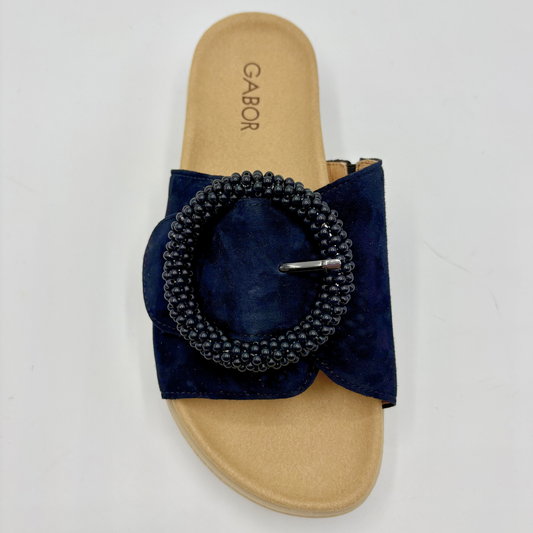 Navy sandal with beaded design on a beige insole against a white background