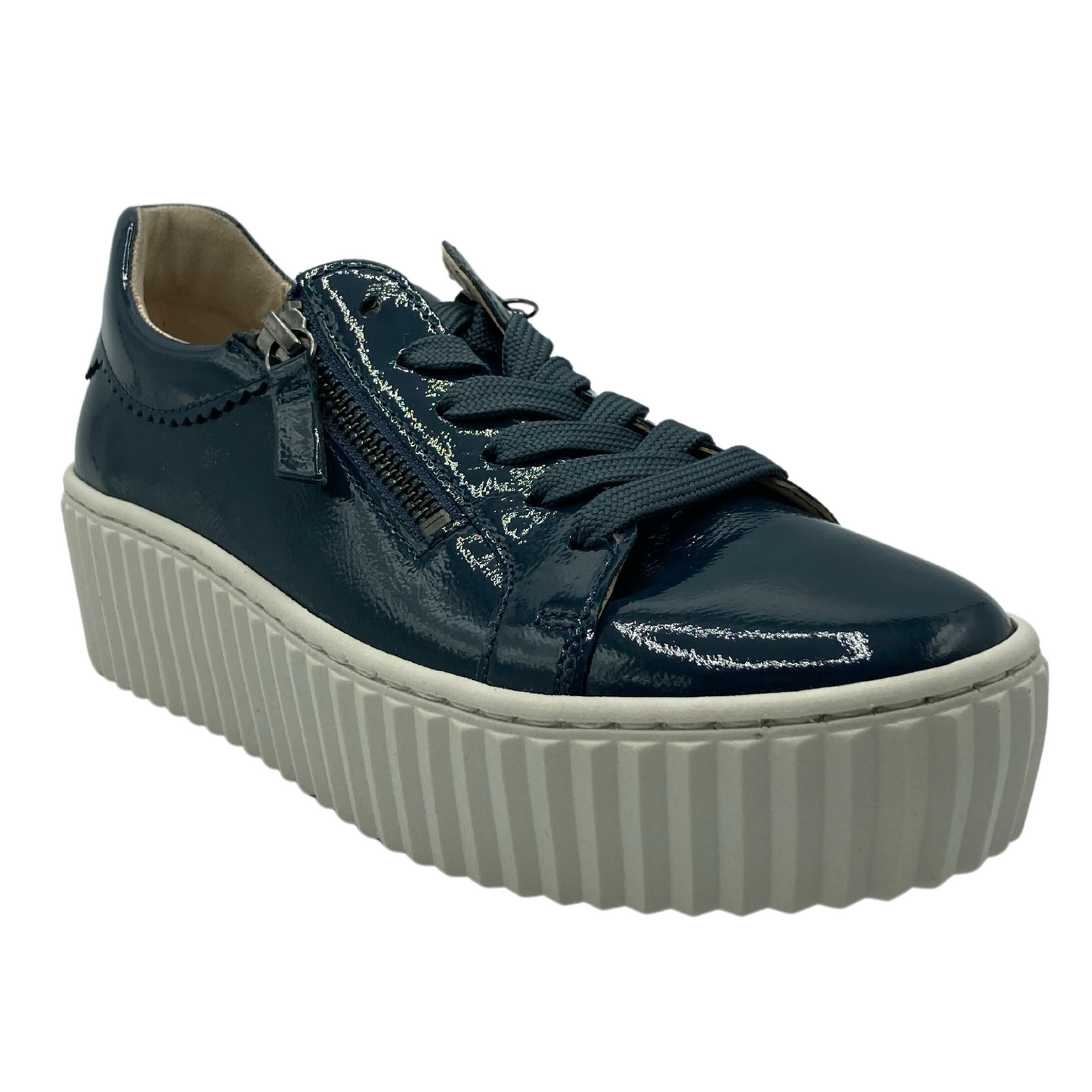 45 degree angled view of patent leather sneaker with white platform sole