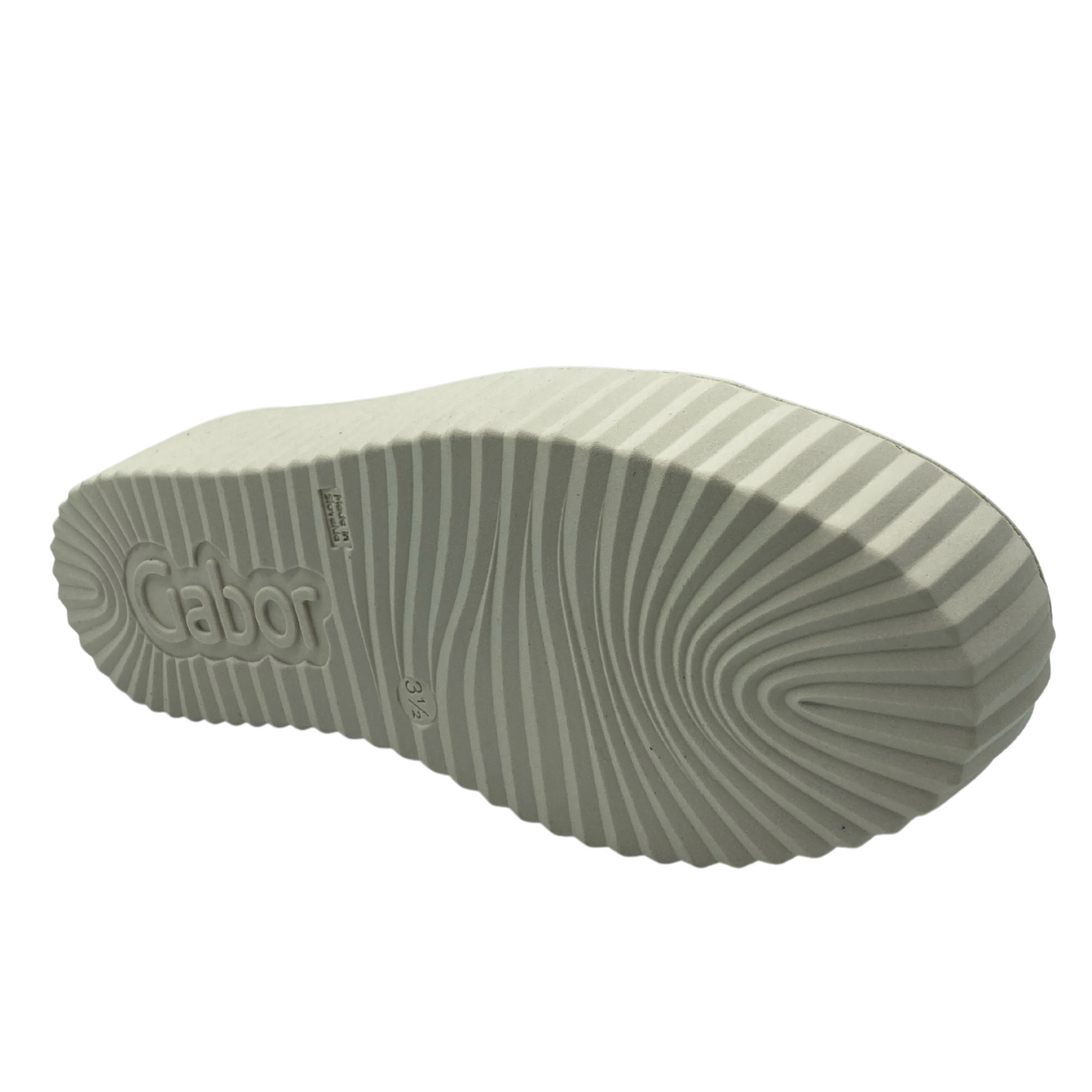 Bottom view of patent leather sneaker with white rubber outsole