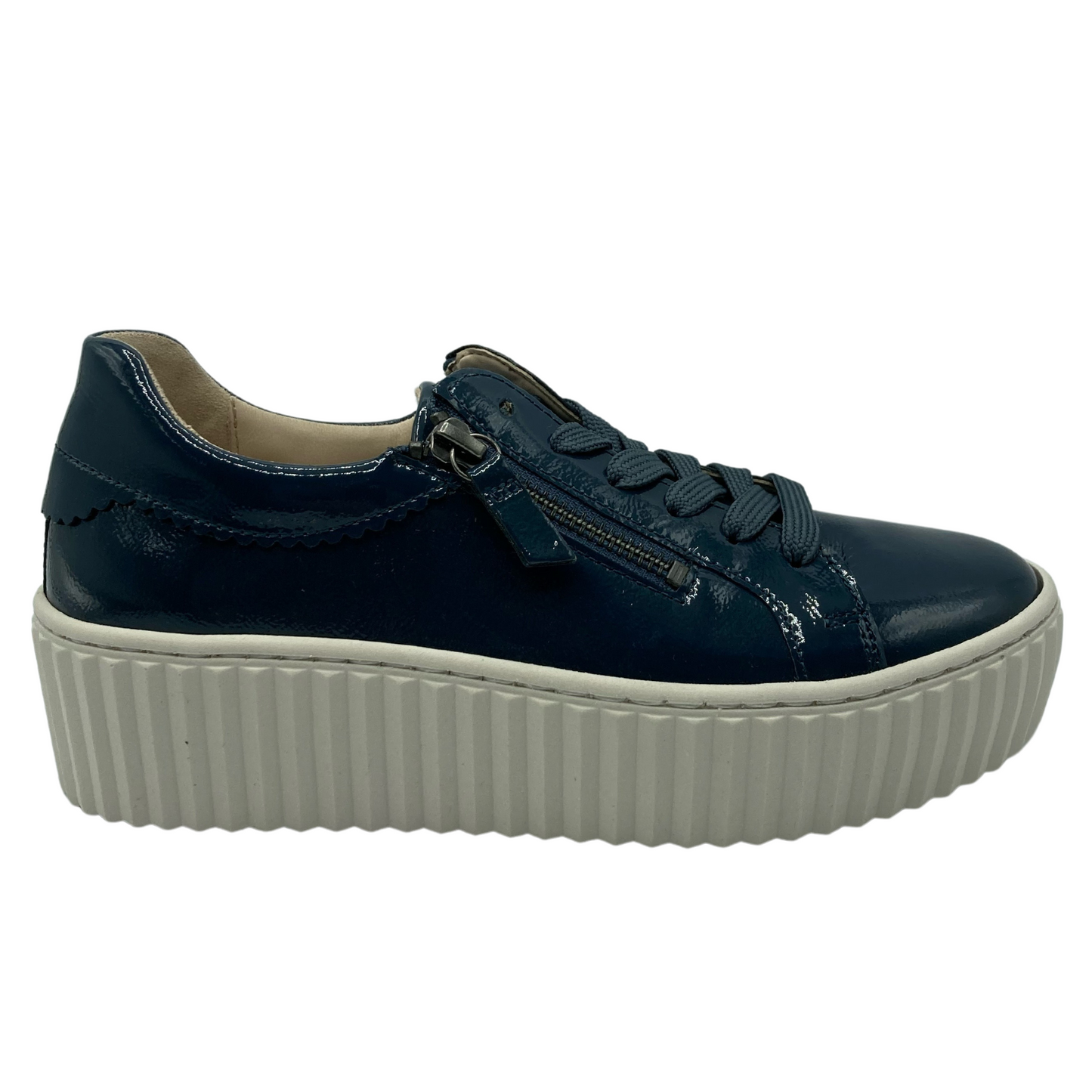 Right facing view of patent leather sneaker with white rubber platform sole
