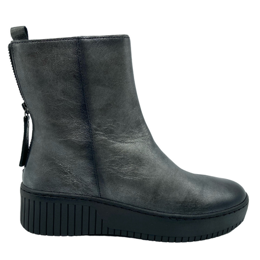 Right facing view of grey leather short boot with platform wedge heel and back zipper closure