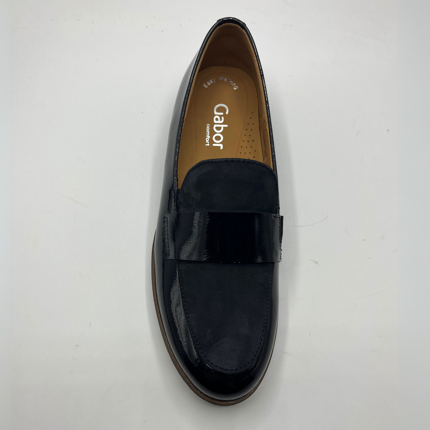 Top view of a black leather loafer with a tan lining