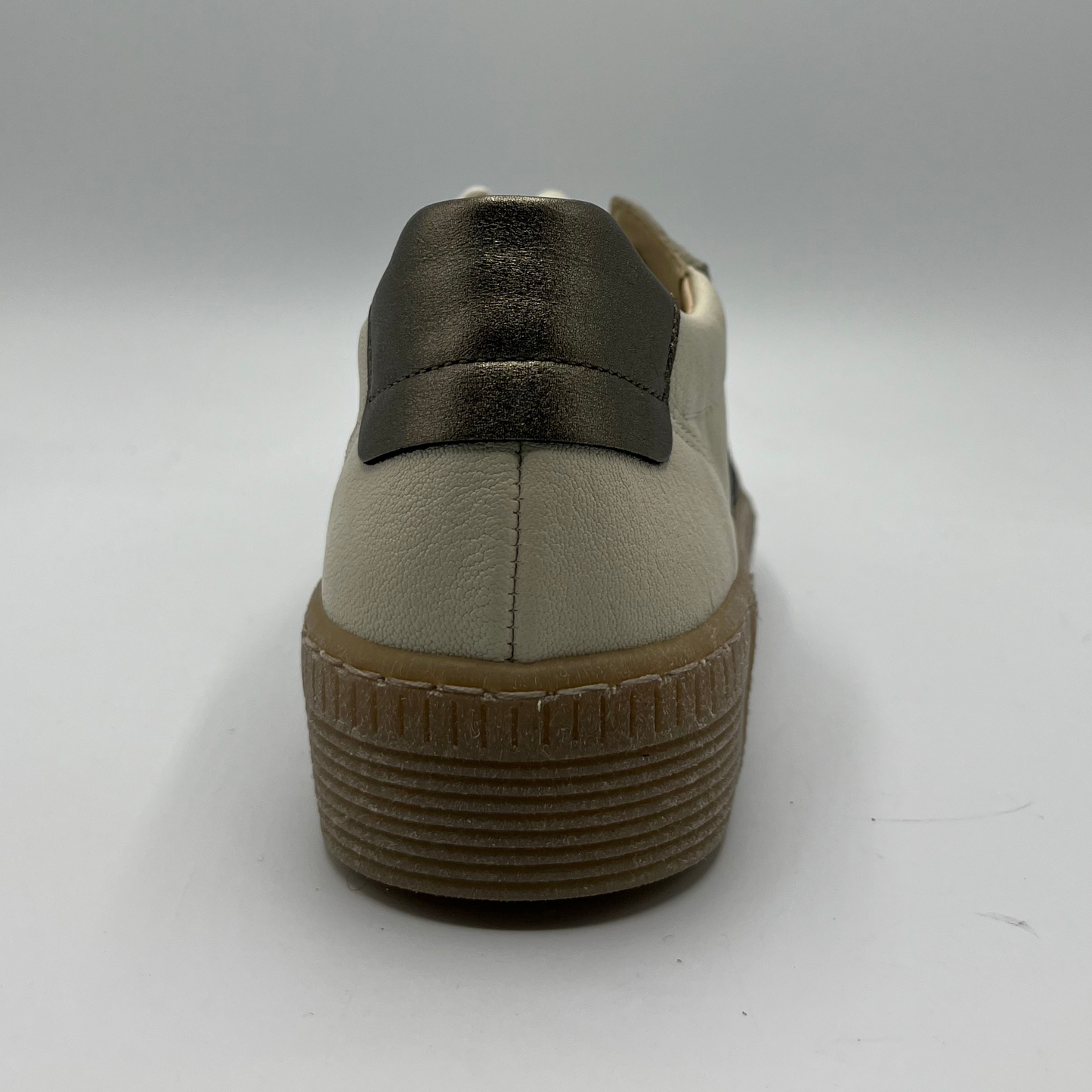Back view of a beige leather shoe with metallic accents and a lace up design