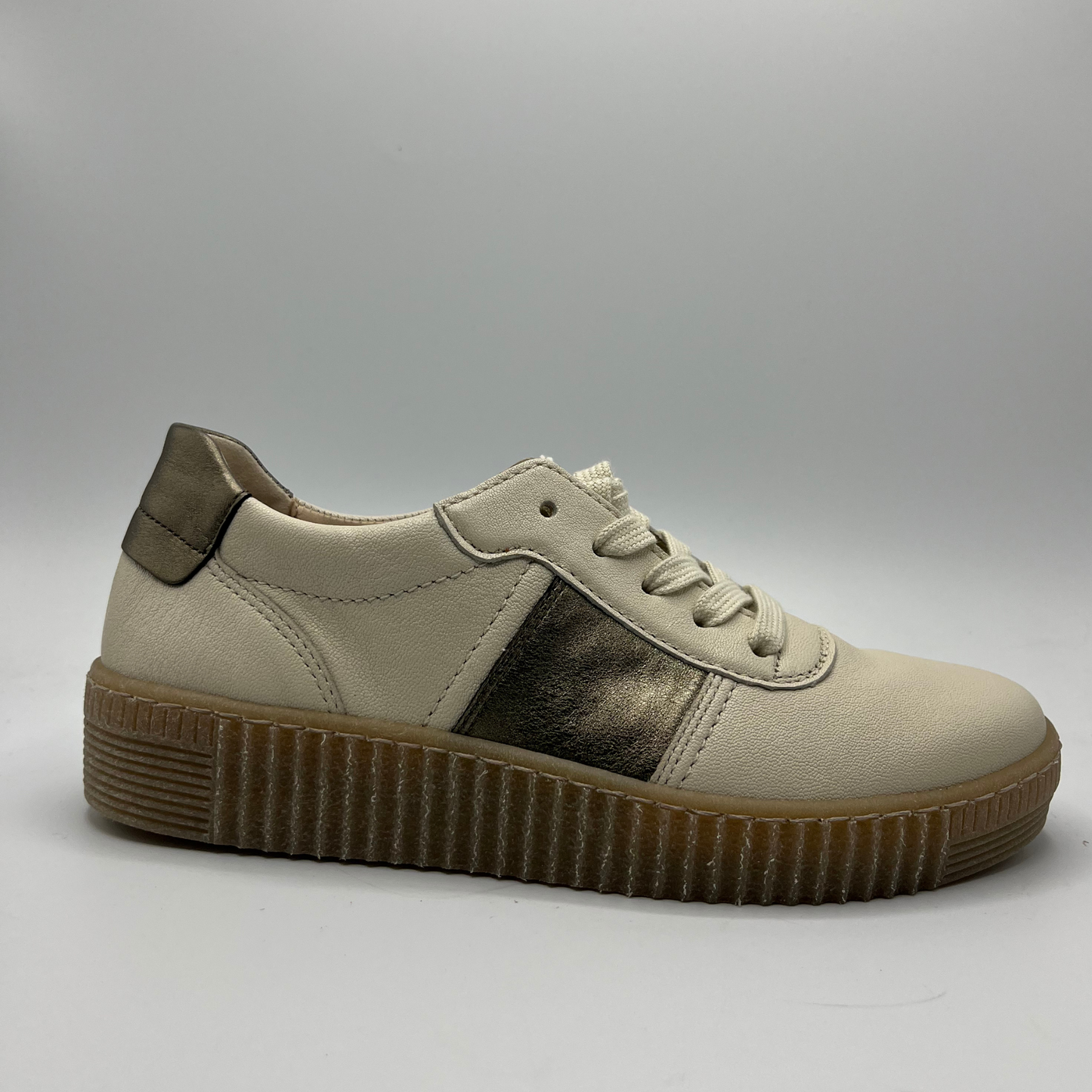 Right facing view of a beige leather shoe with metallic accents and a lace up design