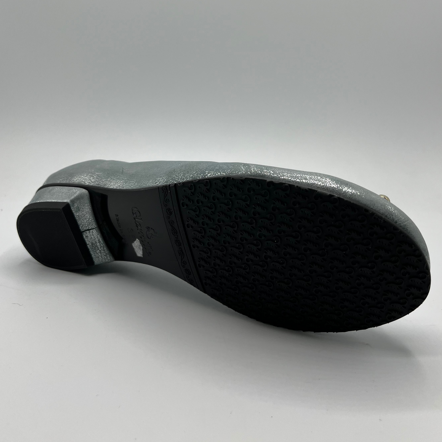 Bottom view of a blue pearl ballet flat with a short wrapped heel, cushioned insole and stretchy upper.