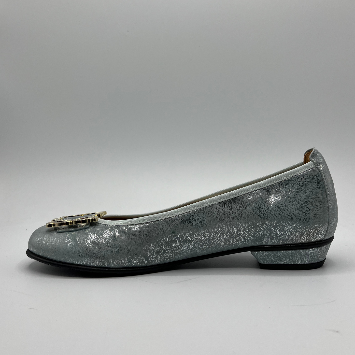 Left facing view of a blue pearl ballet flat with a short wrapped heel, cushioned insole and stretchy upper.