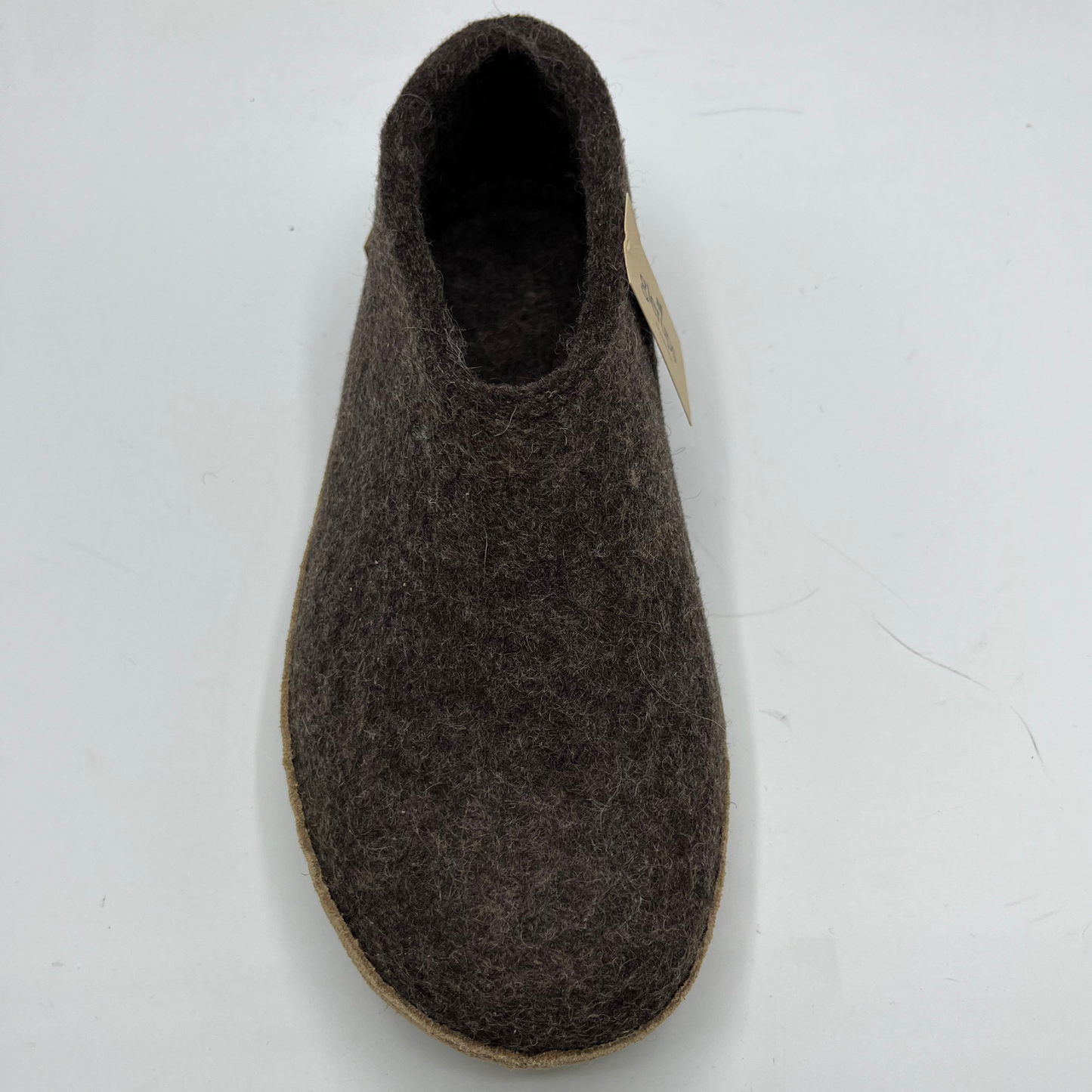 Brown felted slippers on a white background