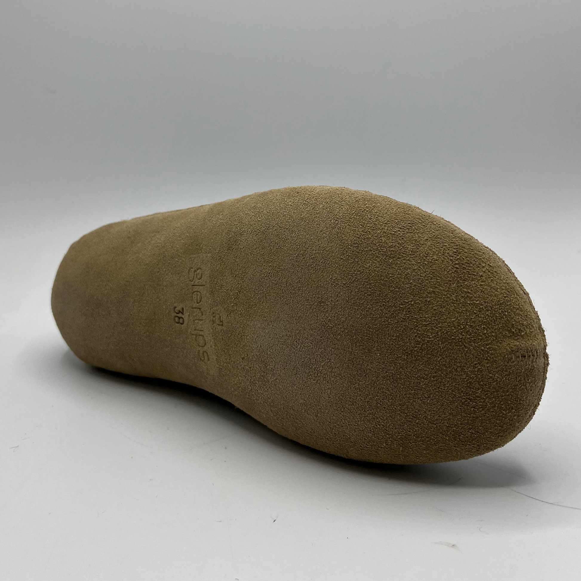 Brown shoe insole on a gray background