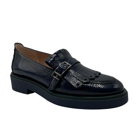 45 degree angled view of midnight blue leather loafer with low heel and adjustable buckle on upper.