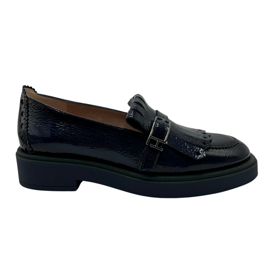Right facing view of midnight blue leather loafer with low heel and adjustable buckle on upper.