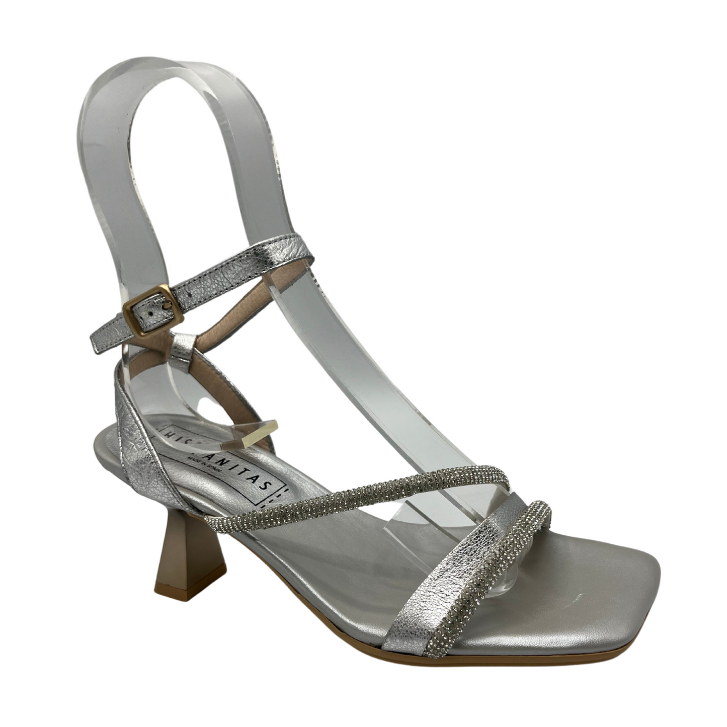 Angled view of silver leather strappy sandal with a flared kitten heel and embellished accent straps.