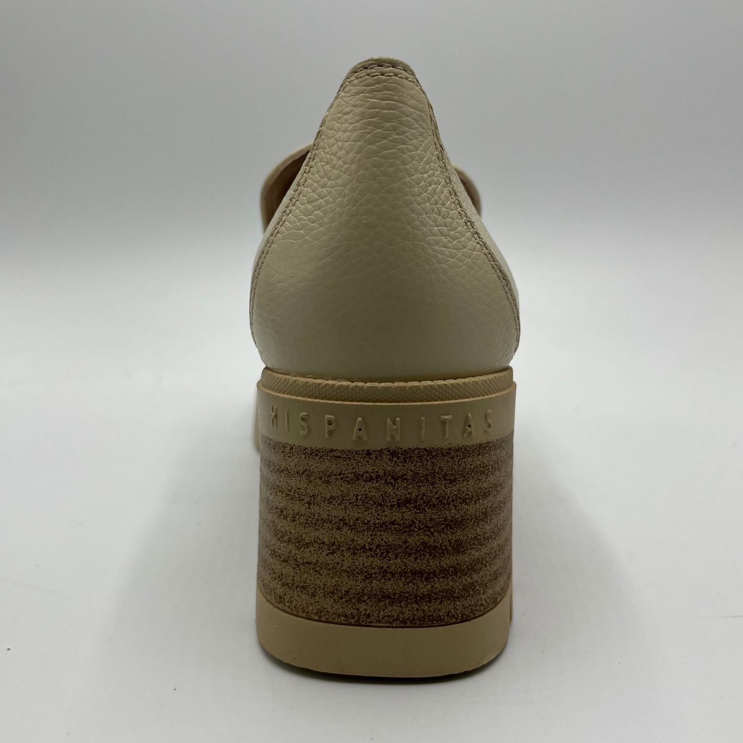 Beige shoe with 'Hispanitas' branding on a white background