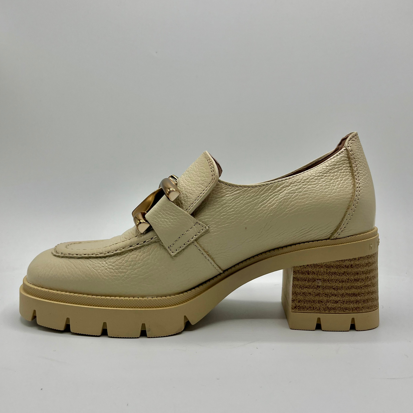 Beige loafer shoe with a chunky sole on a gray background