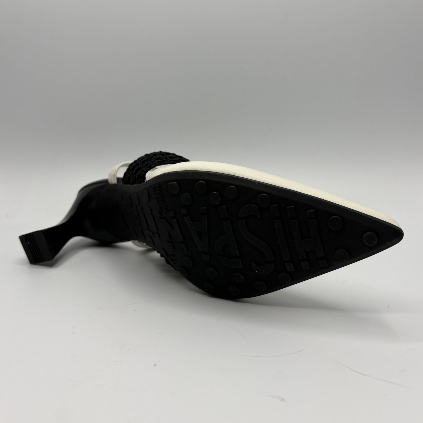 Black shoe sole with white tread pattern on a gray background