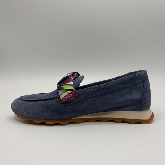Left facing view of a blue suede loafer with a scarf accent