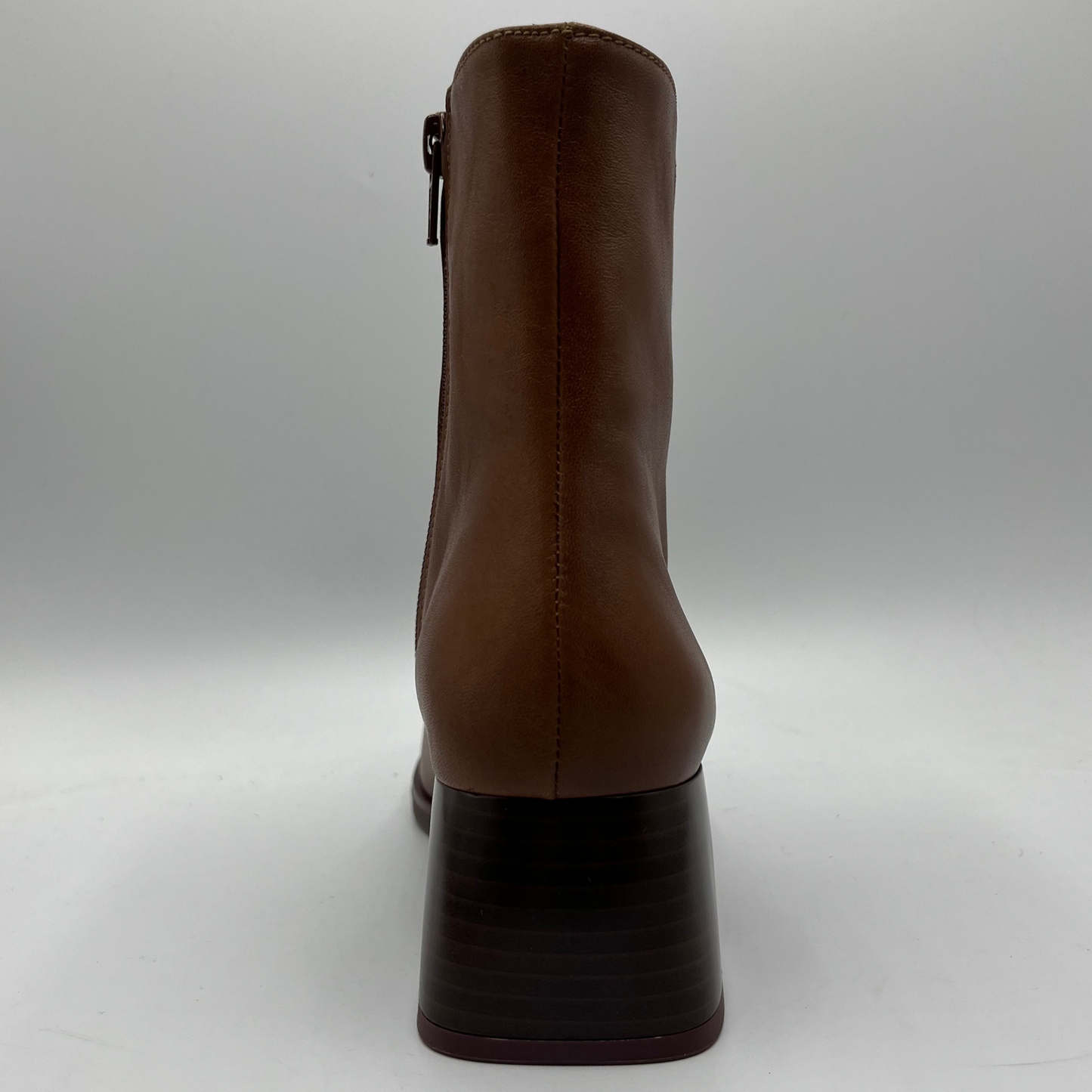 Brown ankle boot on a gray background