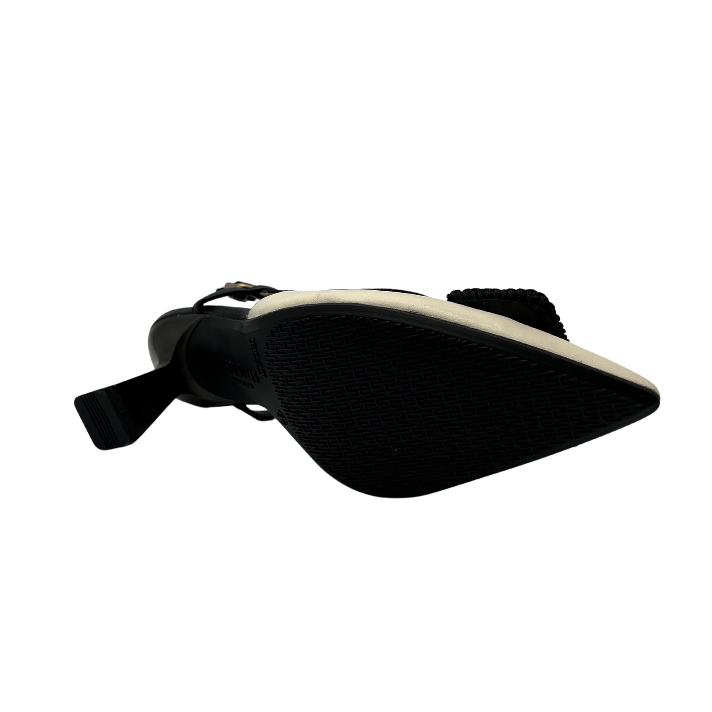 Bottom view of black and ivory leather pump with flared heel and slingback strap.