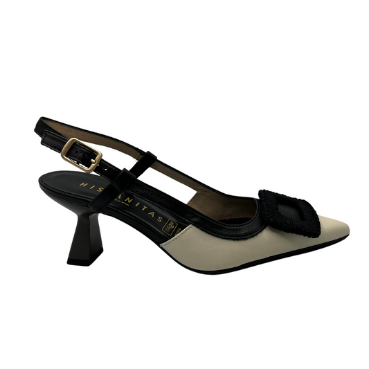Right facing view of black and ivory leather pump with flared heel and slingback strap.