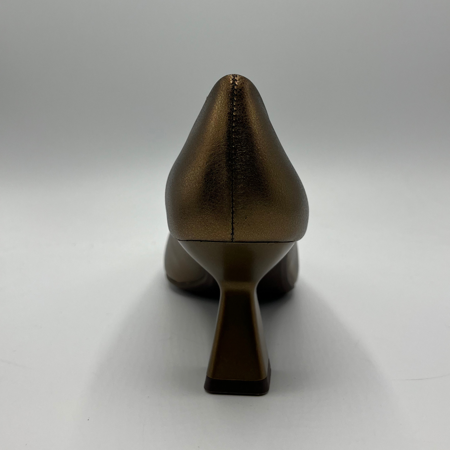 Bronze high-heeled shoe on a white background
