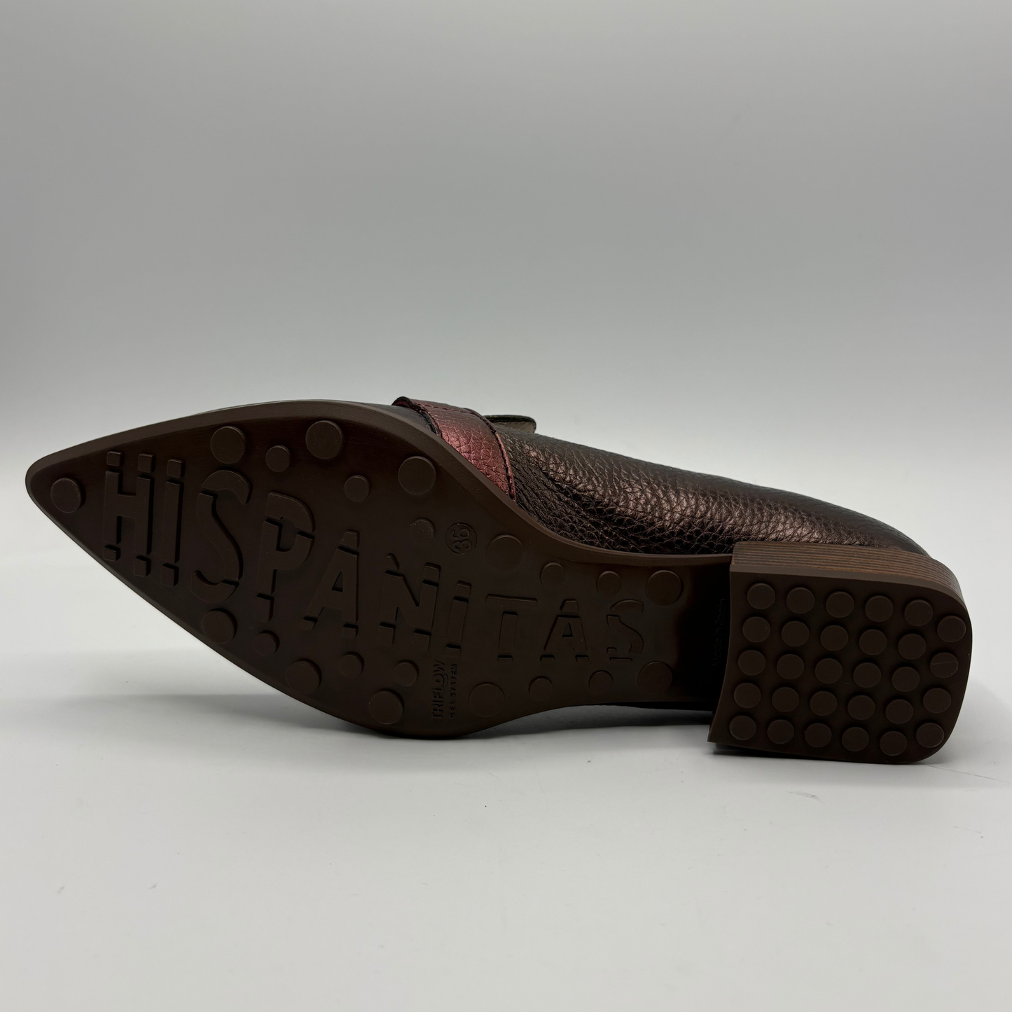 A single brown leather shoe shown from the side, displaying its textured pebbled upper, pointed toe, and a dark brown rubber sole with 'HISPANITAS' embossed in large letters.