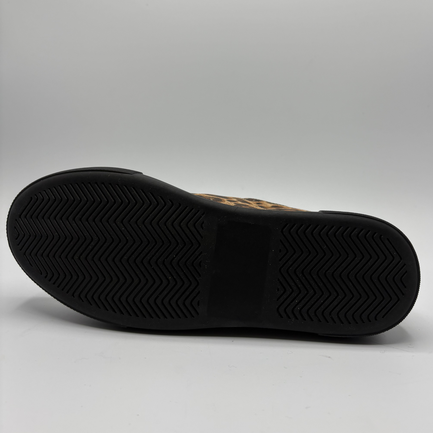 A low-top platform sneaker featuring a brown and black leopard print upper, red patent leather side panels, a gold zipper, and a thick black platform sole.