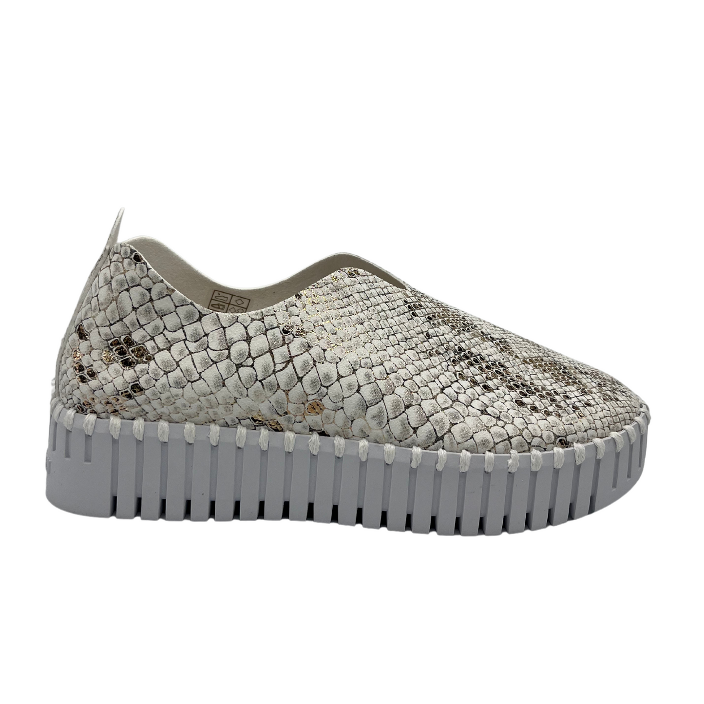 Right facing view of leather snake print sneaker with platform white rubber outsole