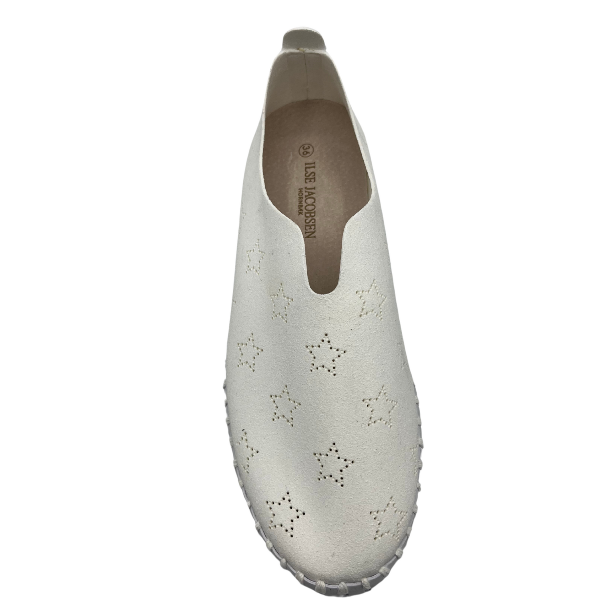 Top view of white slip on sneakers with small star cutouts on upper. White rubber platform sole.