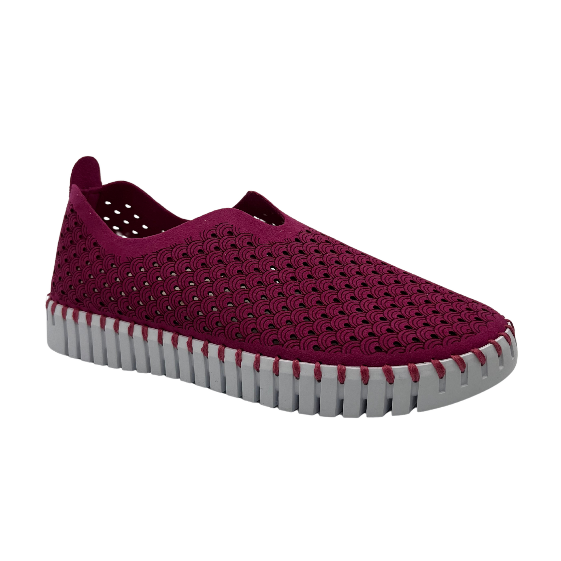 45 degree angled view of maroon embossed cutout slip on sneakers with white rubber outsole