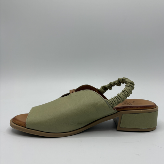 Green sandal with a block heel on a white background