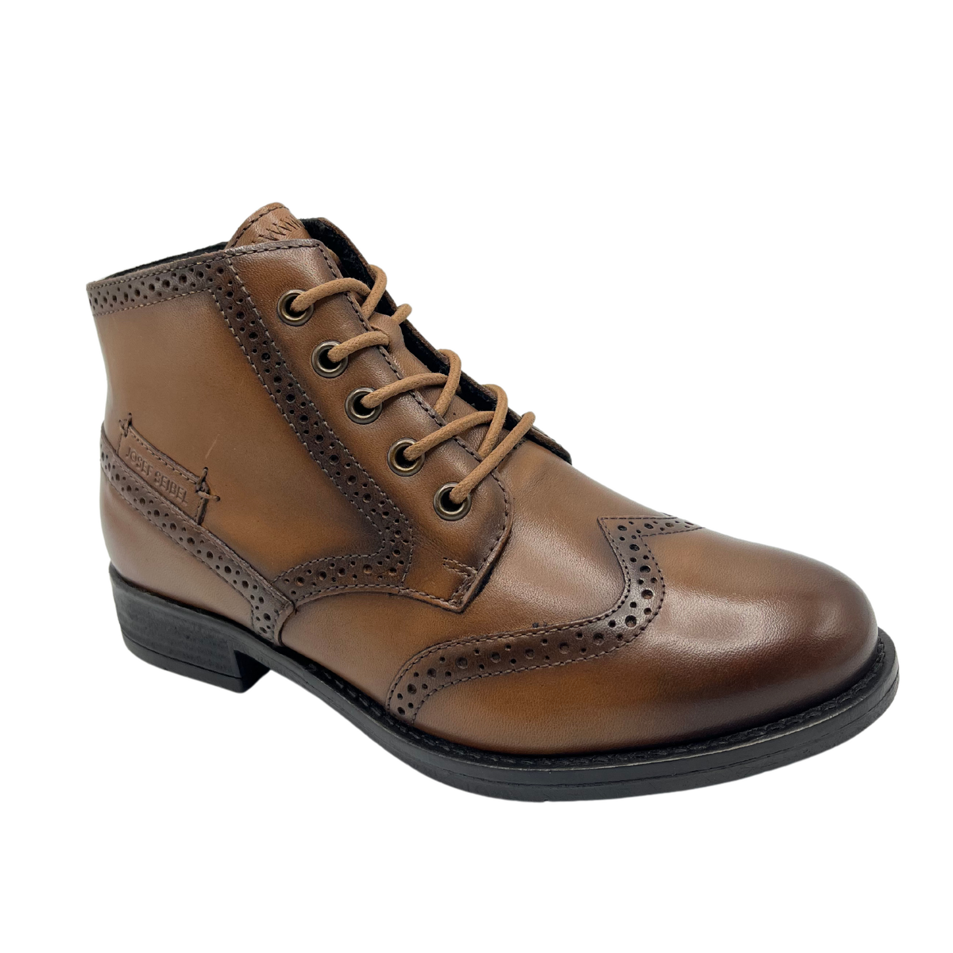 45 degree angled view of brown leather boot with perforated border details. Lace up front and inner side zipper.