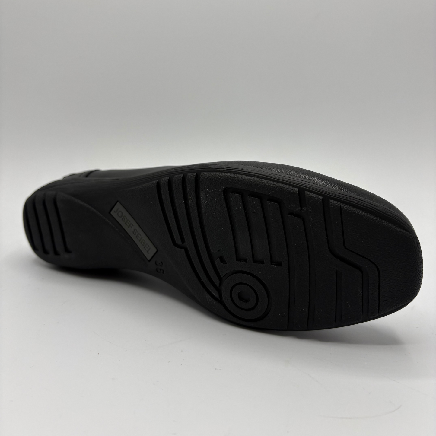 Black shoe sole on a light gray background