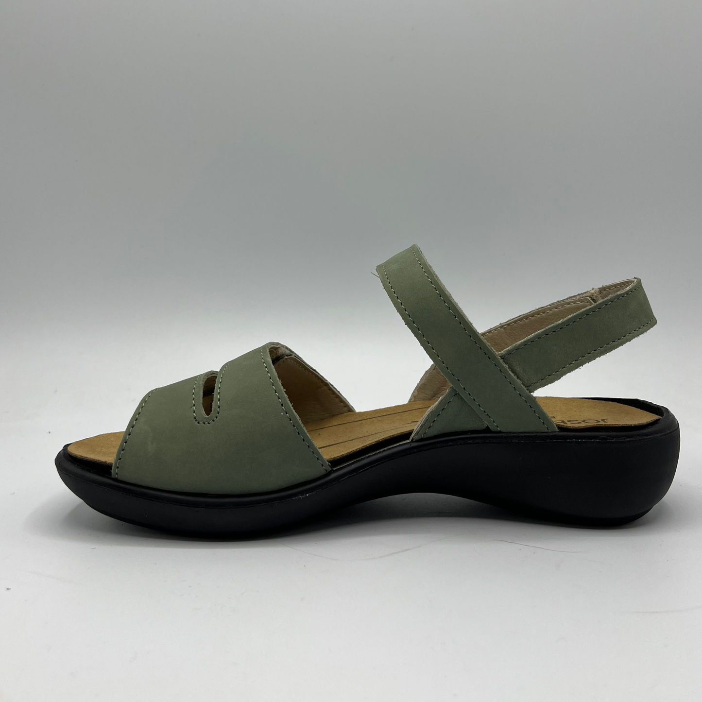 Left facing view of a green nubuck leather sandal with 4 adjustable hook and loop straps, a contoured footbed and a black outsole.